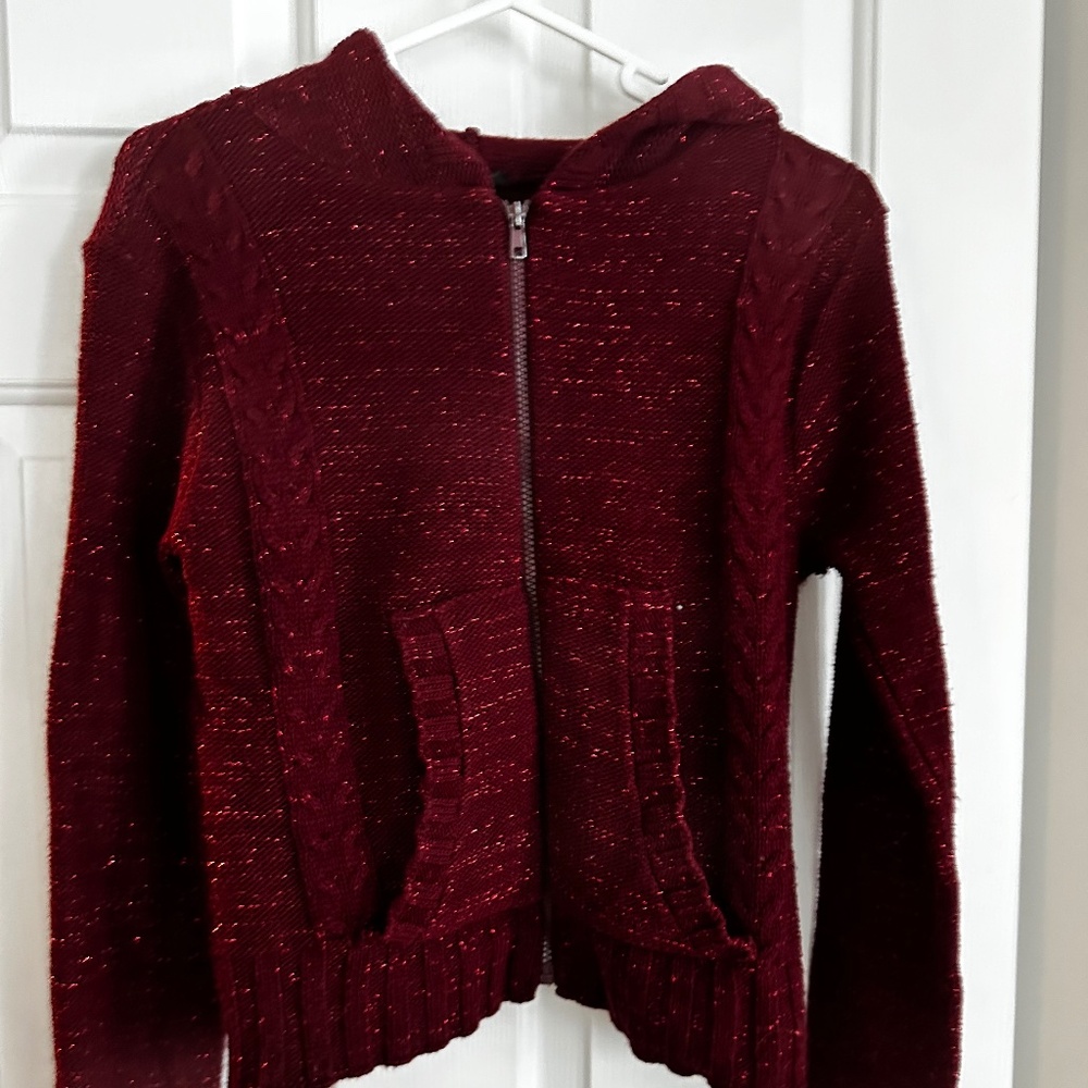 Very sparkly red zip-up hooded sweater.Says small but runs a little  big